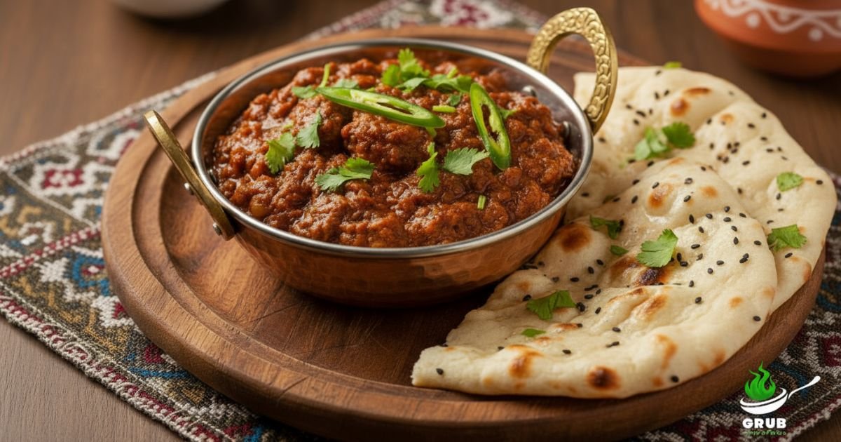 Spicy Brain Masala served in a copper bowl with naan and fresh coriander garnish
