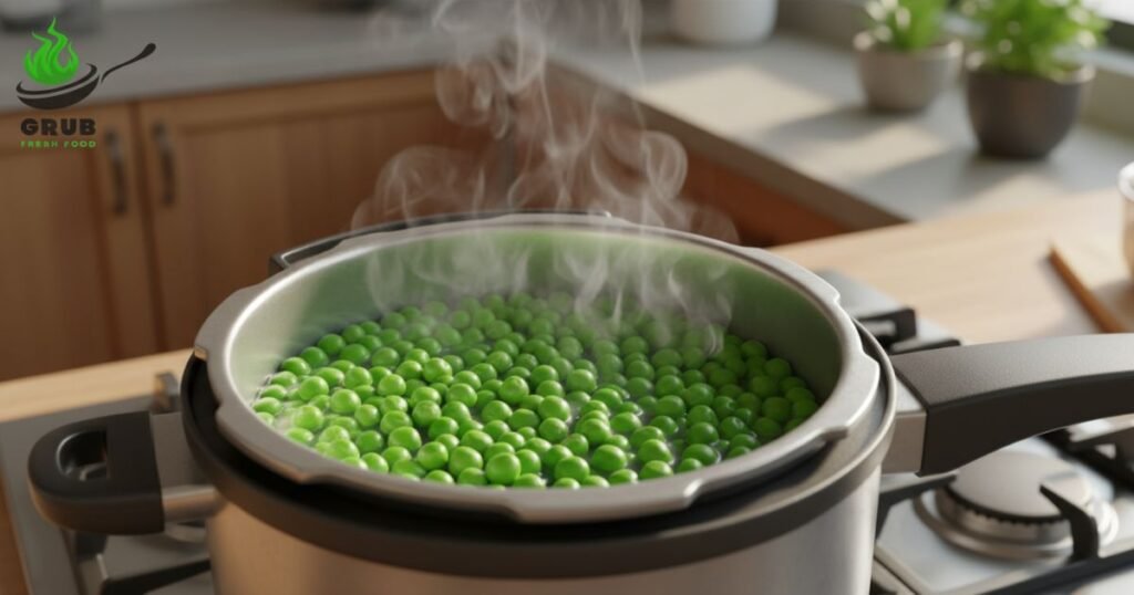 Boiled green peas in a pressure cooker with steam rising.