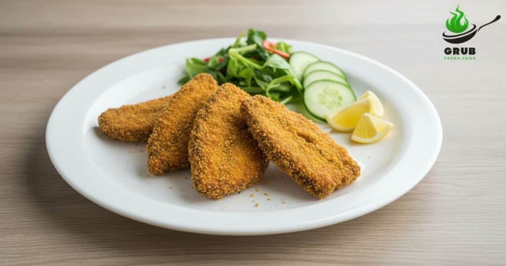Healthy rava fish fry served with fresh salad and lemon.